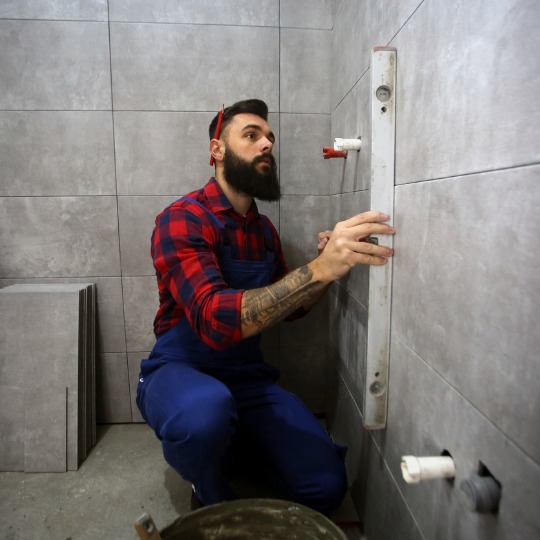 man doing bathroom repairs